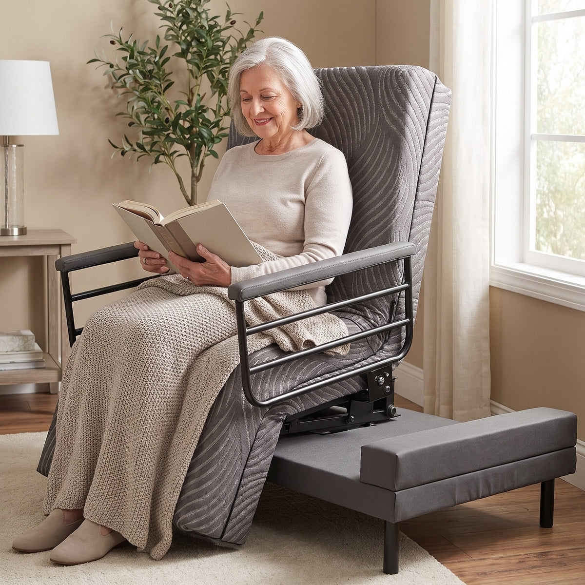 A woman sits on her Independence bed in a softly lit room, holding and reading an open book.